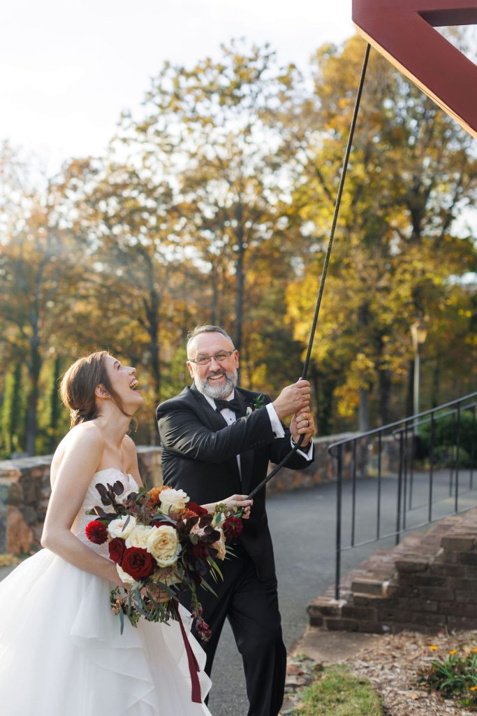 Bride and Groom ringing bell at Wedding at The Rafters at Historic St. Mark’s- Huntersville, NC wedding- fall theme wedding