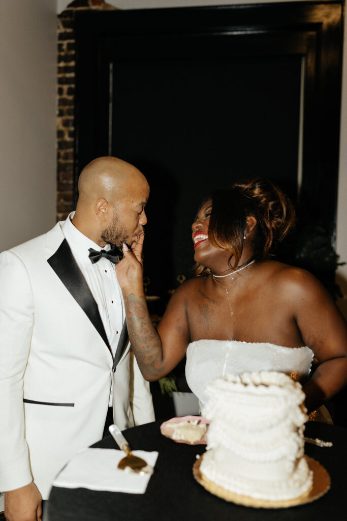 Winter Moody Wedding- Uptown Indigo- Shelby, NC Wedding- Bride and Groom cutting cake