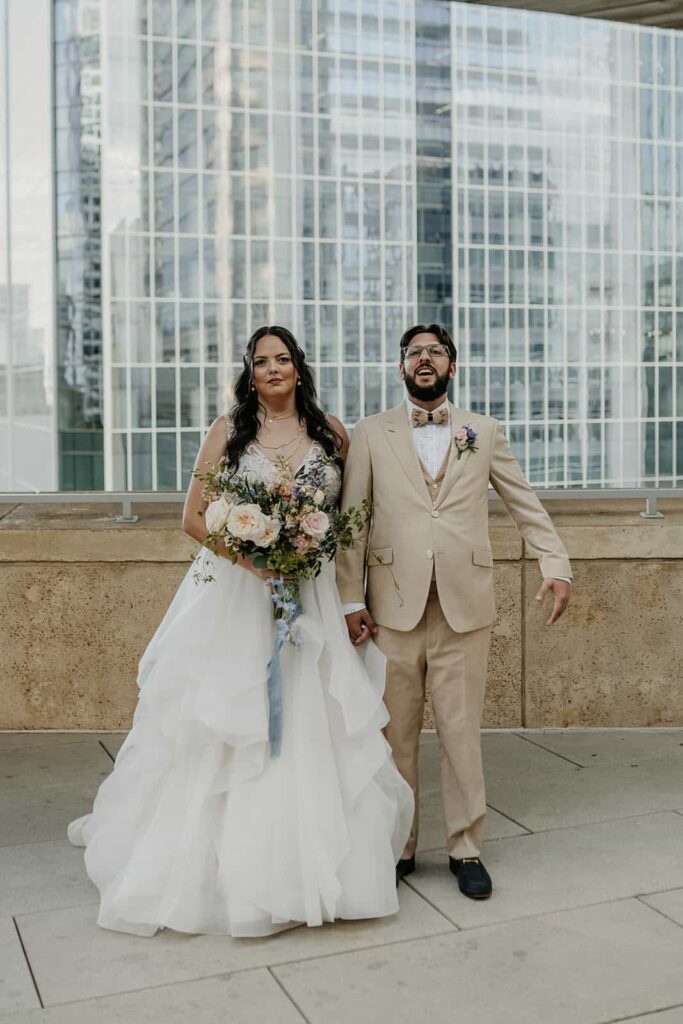 bride and groom portraits- wedding with navy, sage and blush in uptown Charlotte, nc at the mint museum uptown with an art deco wedding style