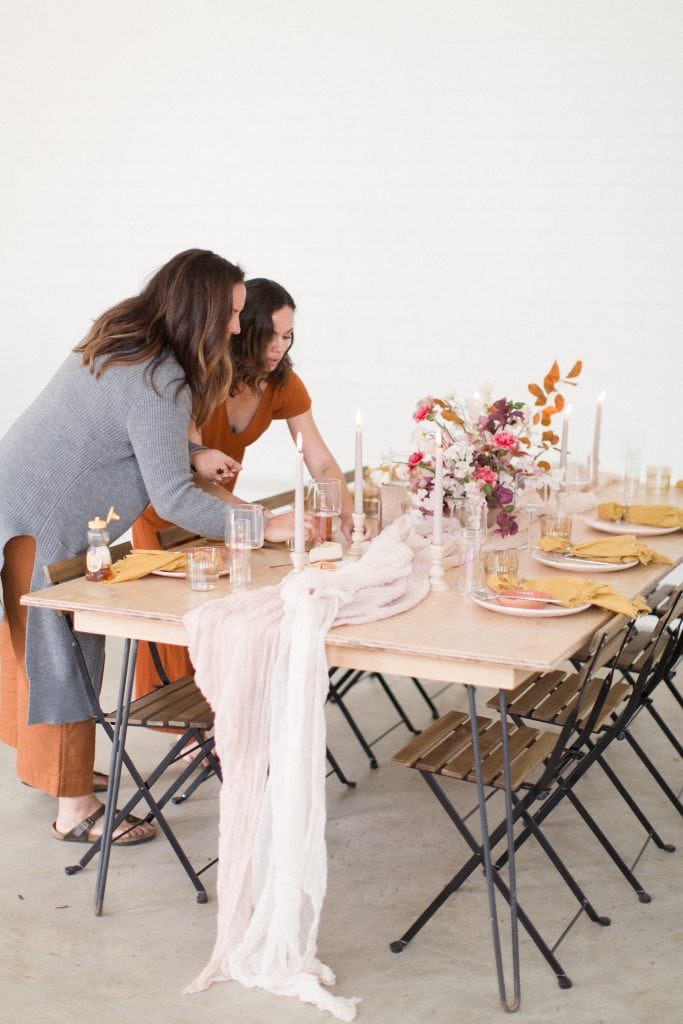wedding day set up by wedding planner setting decor and tables capes and details on reception table