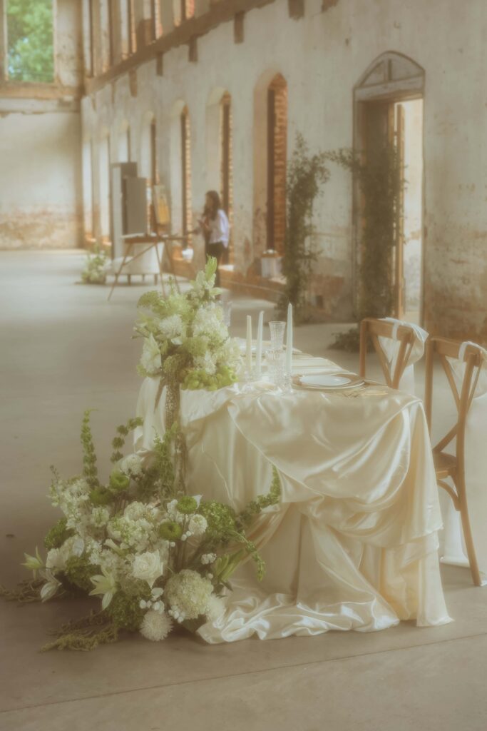 Green and White Southern Luxury Wedding with sweetheart table and draped fabric at Providence Cotton Mill by Crafted Charm
