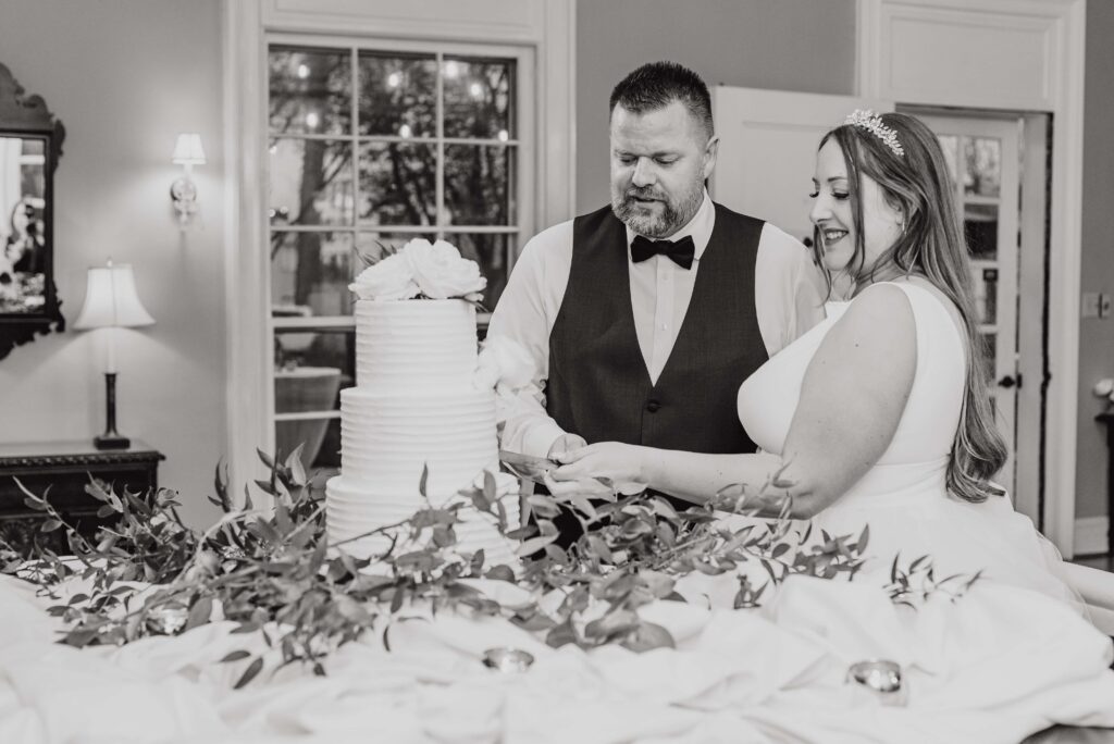 bride and groom cutting cake at the Morehead inn in Charlotte nc at a luxury estate wedding