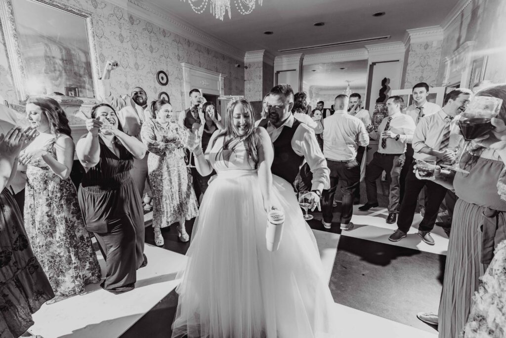 bride and groom and party dancing at the Morehead inn in Charlotte nc at a luxury estate wedding