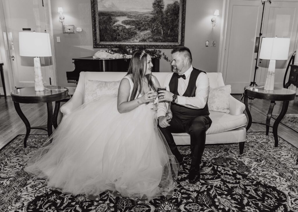 bride and groom sharing a drink at the Morehead inn in Charlotte nc at a luxury estate wedding