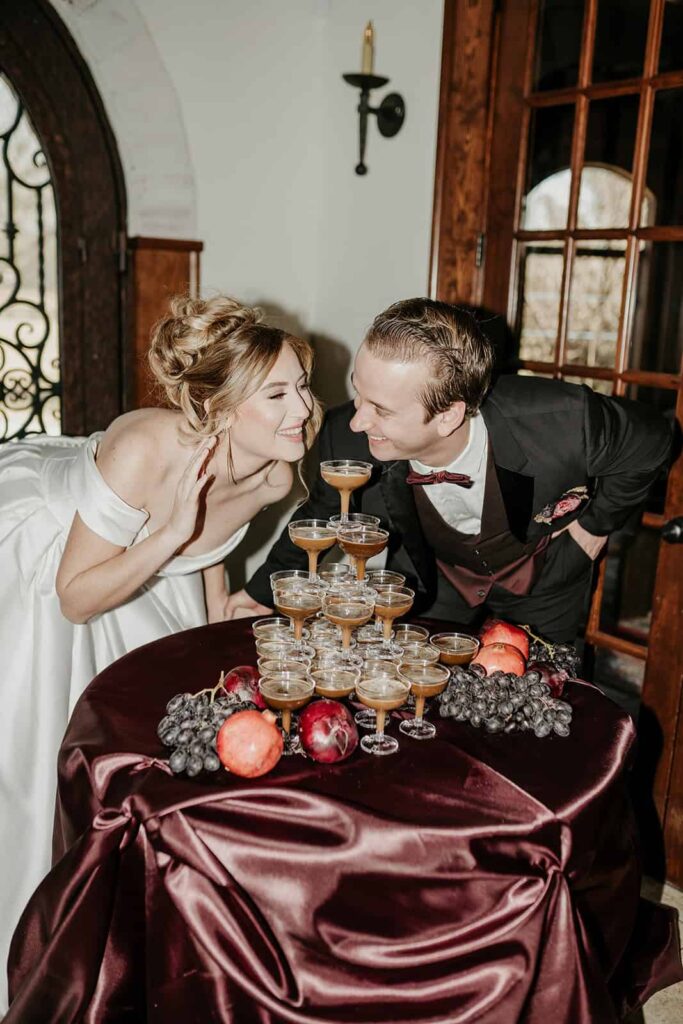Sunset Ridge Estate luxury southern wedding venue in Monroe NC with bride and groom toasting with espresso martini tower at large estate for newlywed portraits