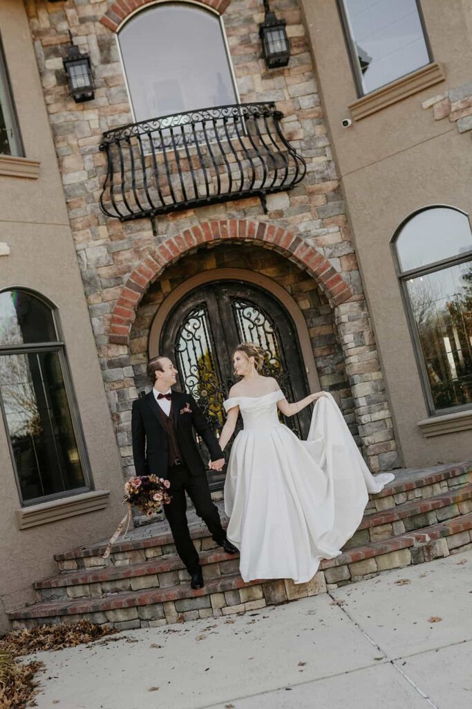 Sunset Ridge Estate luxury southern wedding venue in Monroe NC with bride and groom walking outside of large estate for newlywed portraits