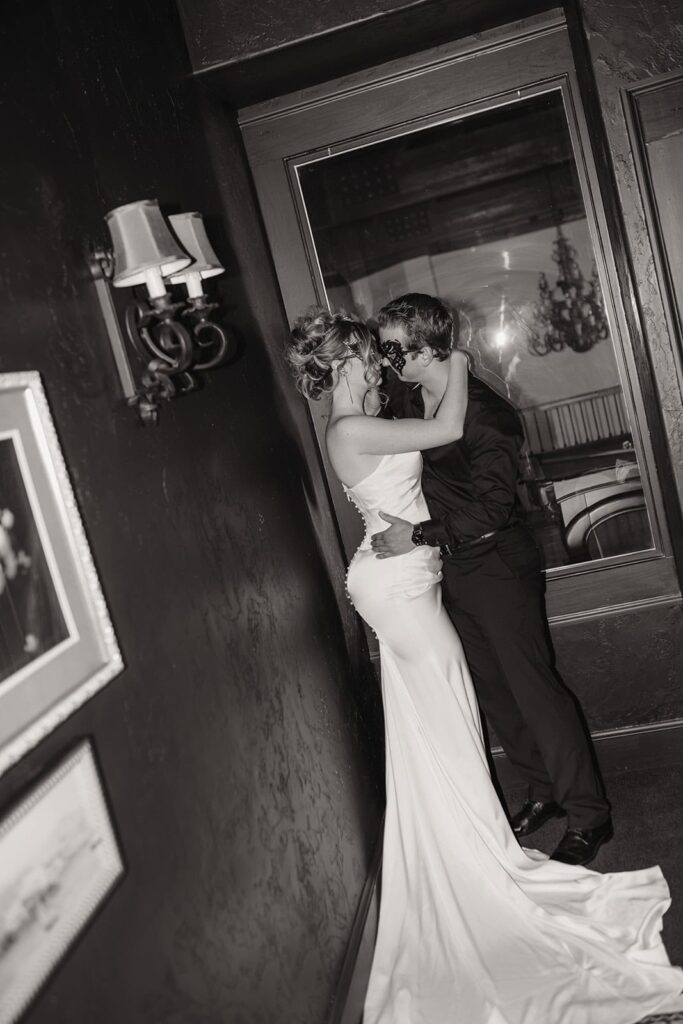 Sunset Ridge Estate luxury southern wedding venue in Monroe NC with bride and groom portraits moody winter luxury backdrop with candles and antique furniture