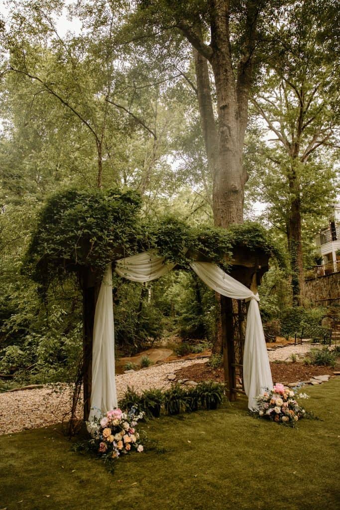 ceremony site with arbor covered in greenery vines at the Historic Robertson Homestead in Rock Hill, SC