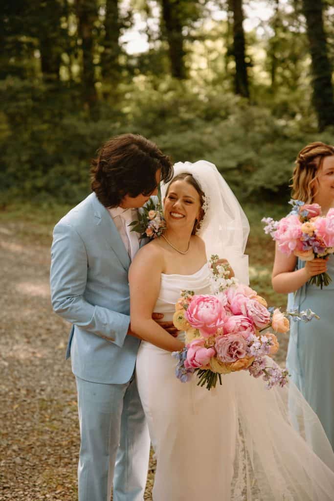 bride and groom portrait with bride carrying large floral bouquet of spring colors and peonies at the Historic Robertson Homestead in Rock Hill, SC