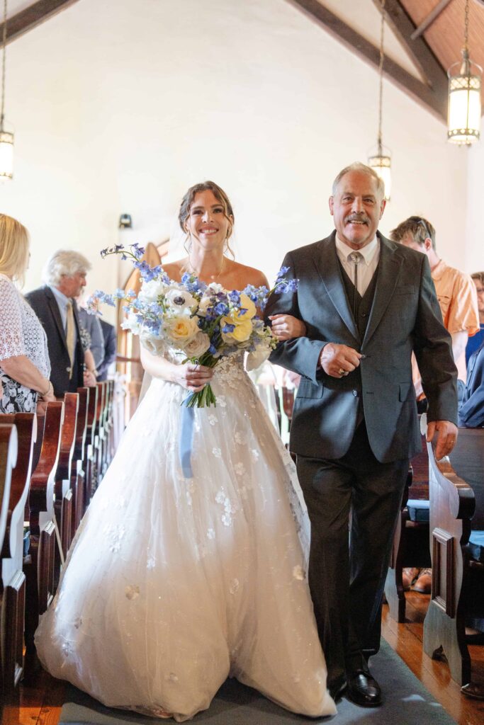 Father walking down bride during ceremony chapel at The Rafters at Historic St. Mark in Huntersville, NC at a classic blue and white styled wedding.