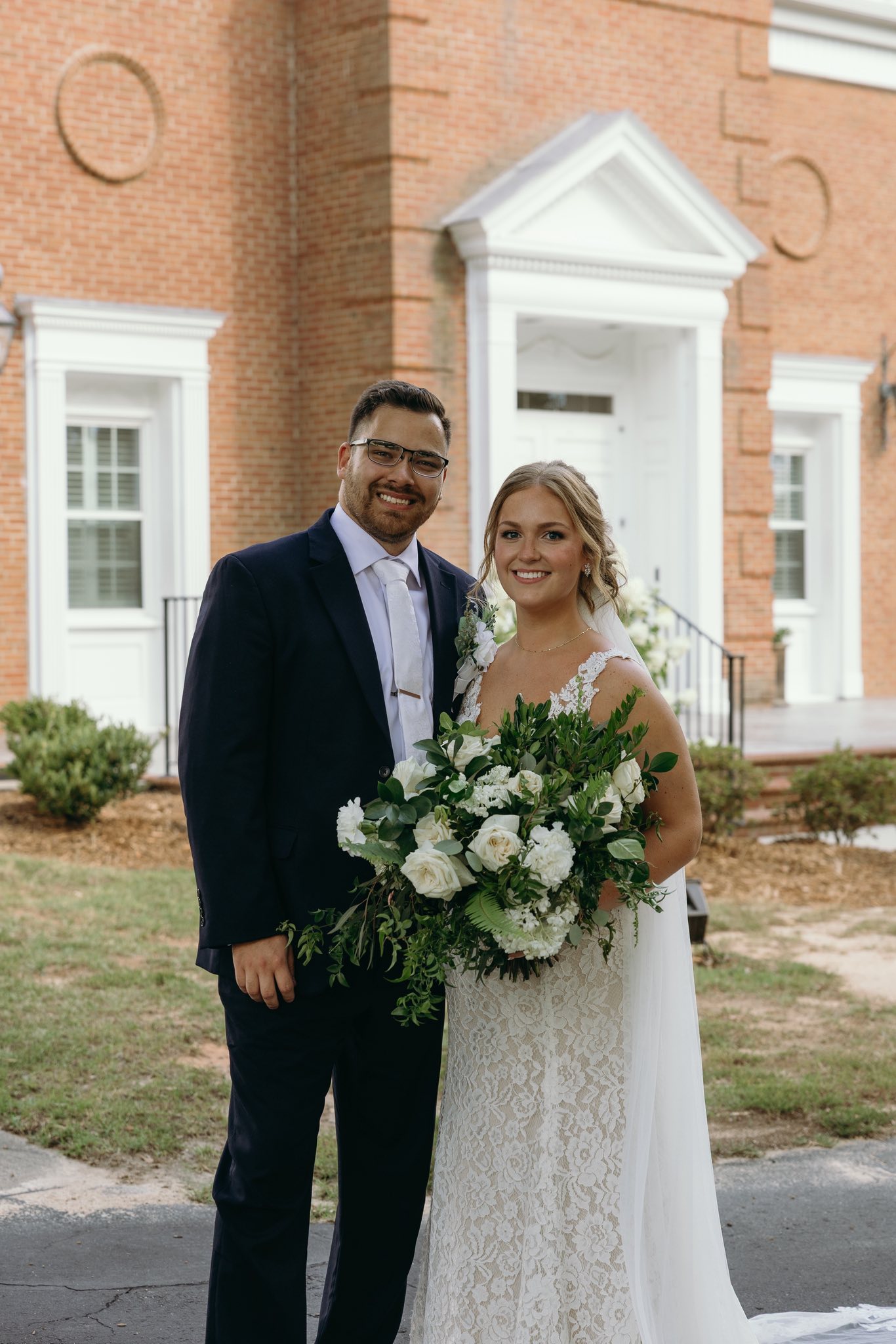 bride and groom portraits at historic Robertson homestead in rock hill SC at a classic white and green styled wedding in a natural setting and historic estate