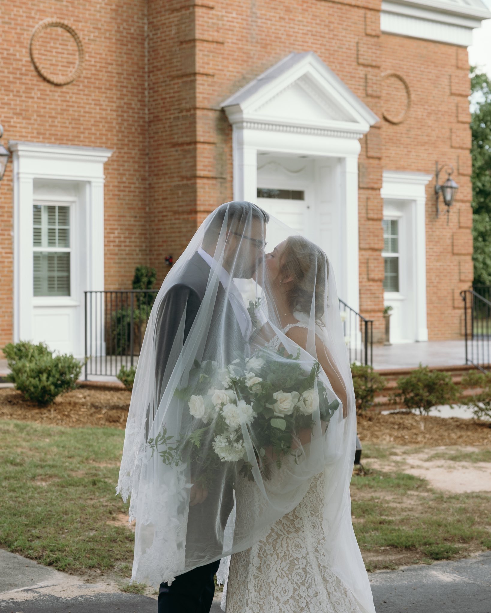 bride and groom portraits at historic Robertson homestead in rock hill SC at a classic white and green styled wedding in a natural setting and historic estate