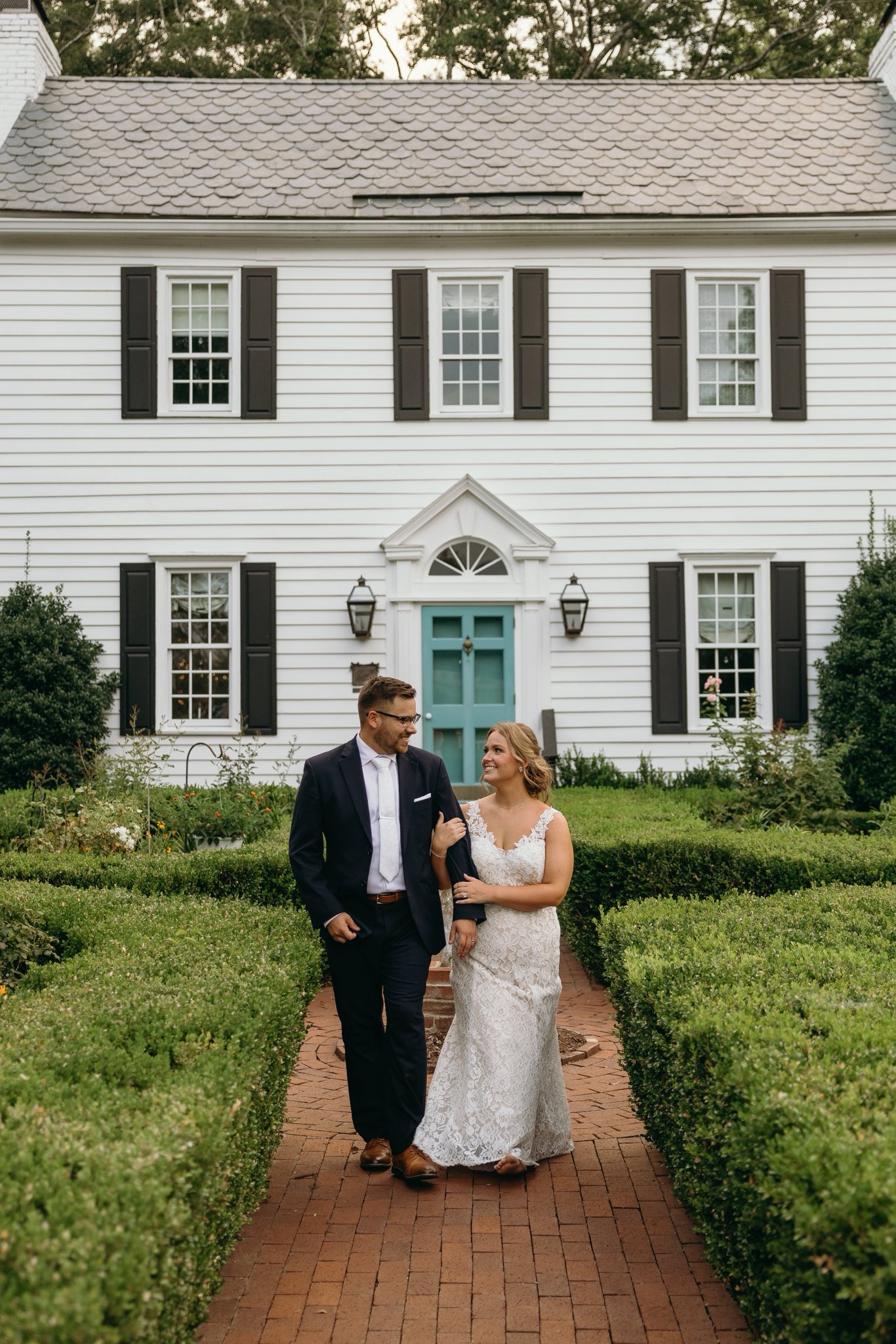 bride and groom portraits at historic Robertson homestead in rock hill SC at a classic white and green styled wedding in a natural setting and historic estate
