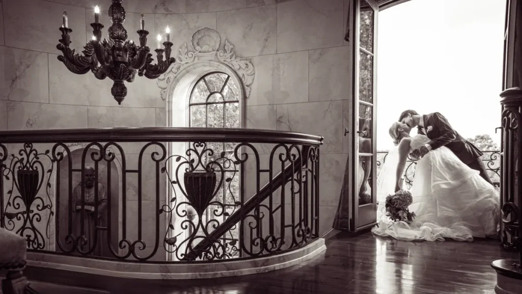 Le Chateau Du Coeur Wedding- bride and groom portrait sharing kiss at stairway
