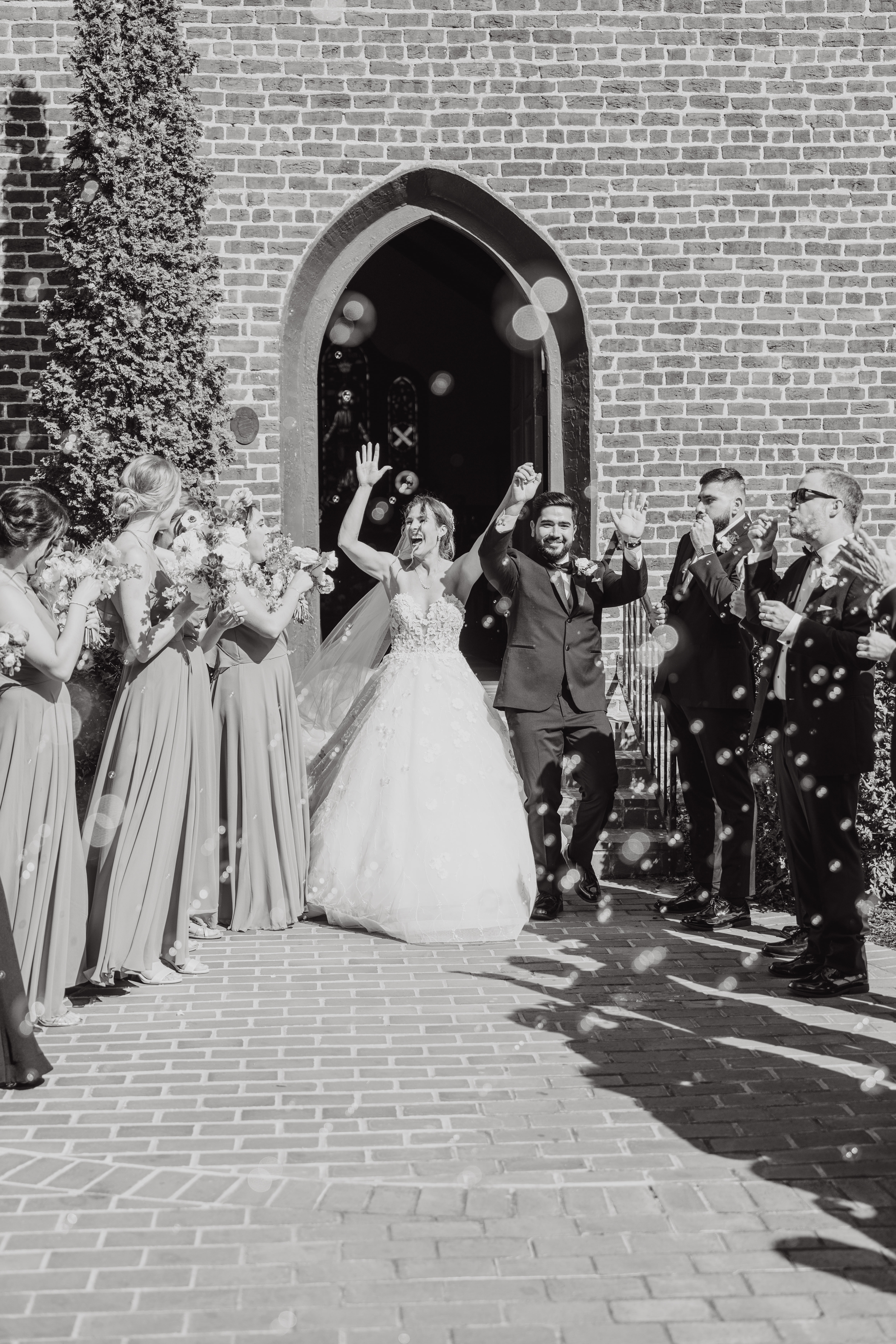 Bride and Groom recess out of chapel for a receiving line with bubbles in Huntersville, NC at The Rafters