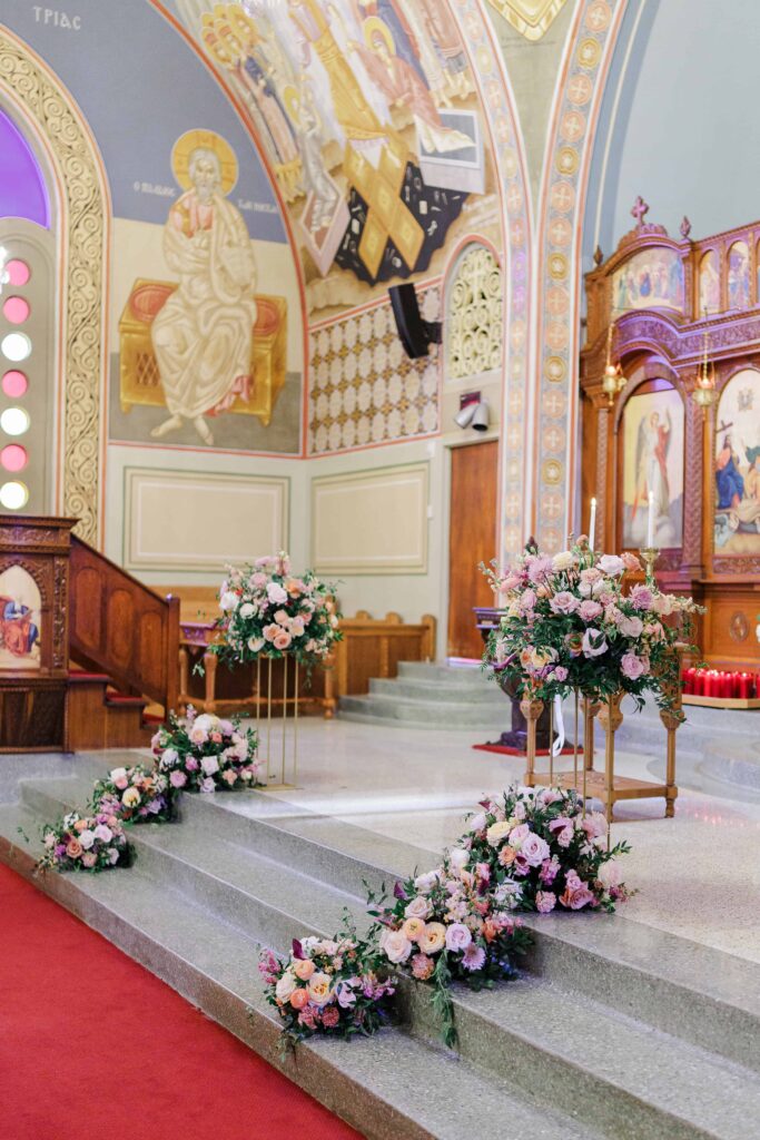 The Holy Trinity Orthodox Cathedral wedding ceremony venue in Charlotte NC decorated in luxury florals with gold and soft pink accents by Crafted Charm Florals